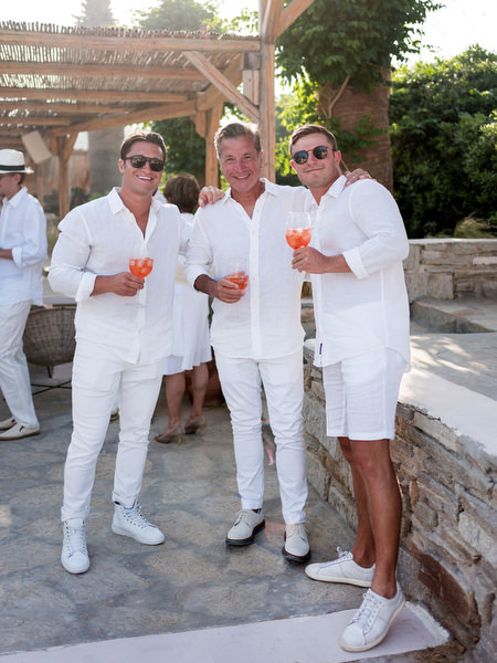 Groomsmen wearing white outfits during Paros wedding welcome event