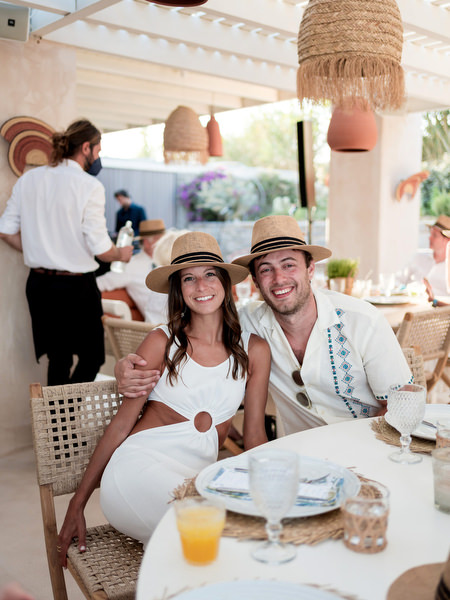 Couple seated at dinner table during Monastiri Beach celebration