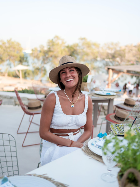 Guest seated at dinner table during Monastiri Beach celebration