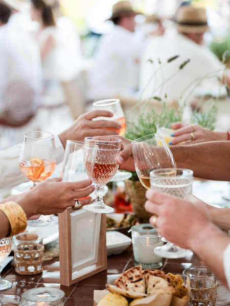 Guests raising glasses during Greek island wedding celebration