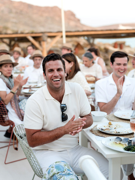 Guests laughing during wedding dinner at Monastiri Beach