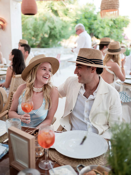 Bride and groom enjoying dinner during Paros wedding weekend