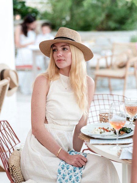 Guest listening to speeches during beachside wedding dinner