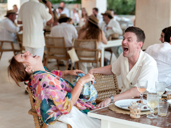 Guests laughing together during Paros wedding welcome dinner