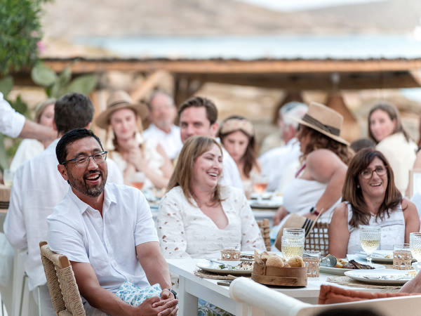 Guests laughing during wedding dinner celebration