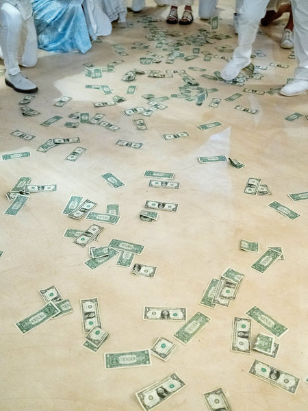 Money scattered on dance floor during Greek wedding tradition