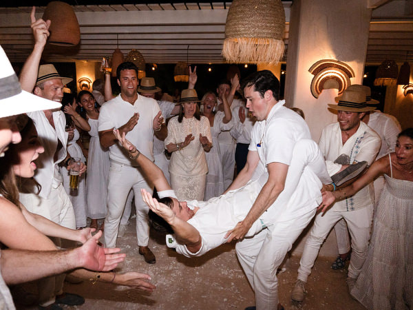 Wedding guests dancing together at Monastiri Beach venue