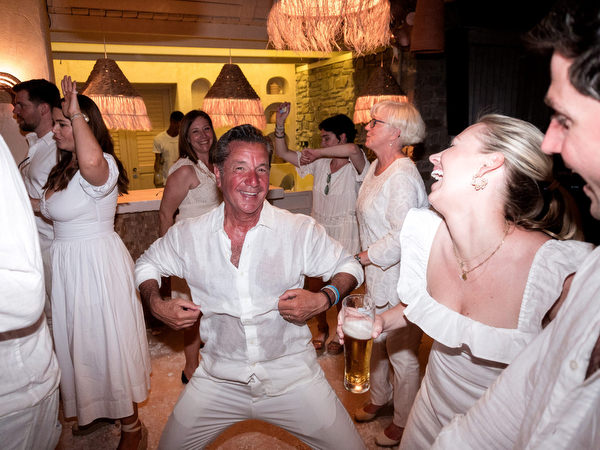 Friends dancing together during wedding party celebration
