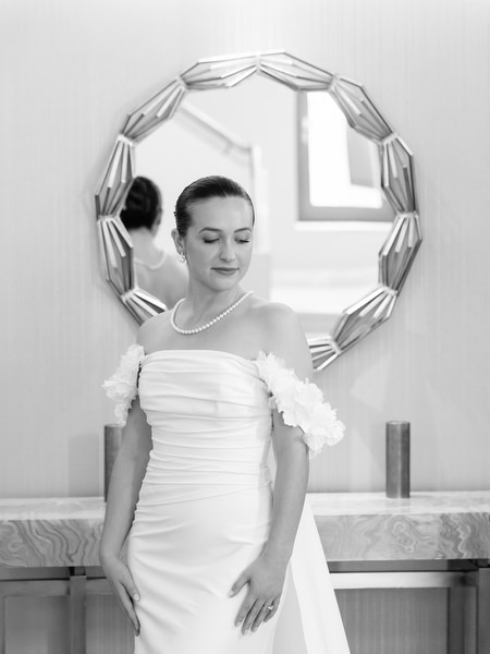 Black and white portrait of bride in structured gown before luxury Athens church wedding.