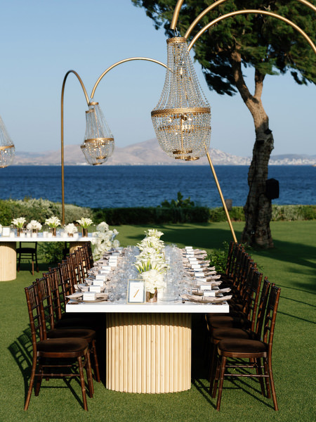 Luxury wedding reception layout at The Residence Island Resort overlooking Athens Riviera at sunset.