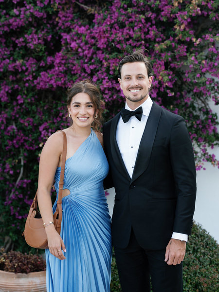 Wedding guest portrait with bougainvillea backdrop at Island Resort Athens Riviera reception.