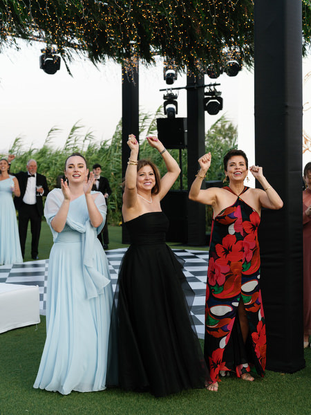 Wedding guests applauding during reception entrance at The Residence Athens Riviera.