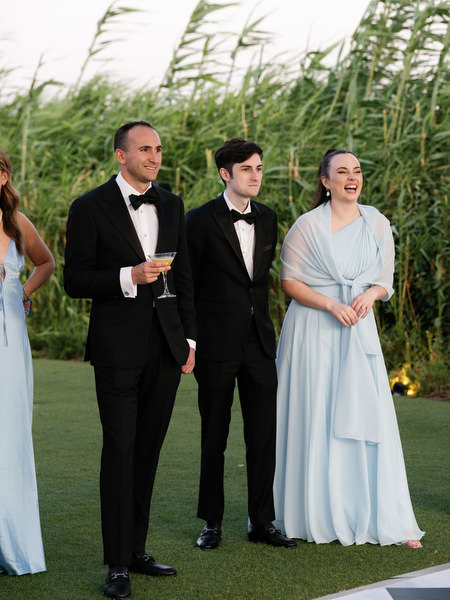 Wedding guests watching reception festivities at The Residence Island Resort Athens Riviera.
