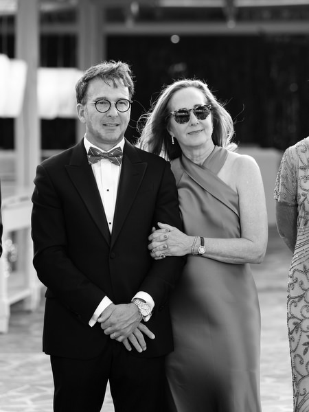 Guests standing together during wedding speeches at Island Resort Athens Riviera reception.