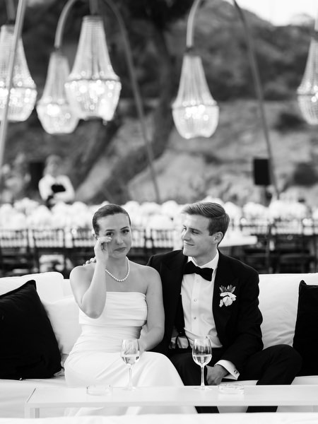 Bride and groom sharing emotional moment during wedding video tribute at The Residence Athens Riviera.