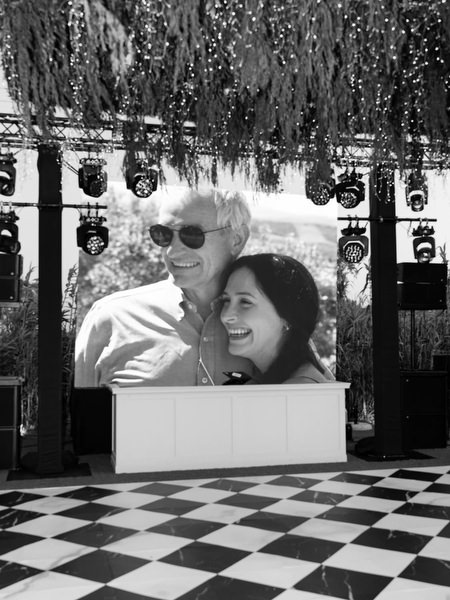 Black and white tribute video displayed during Athens Riviera wedding reception.