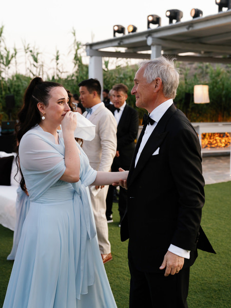 Emotional father and bridesmaid during heartfelt wedding speech at Island Resort Athens Riviera.