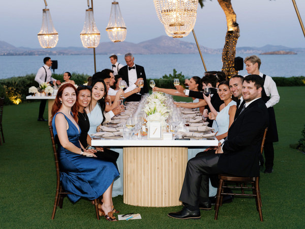 Elegant wedding dinner setup under crystal chandeliers at The Residence Island Resort Athens Riviera.