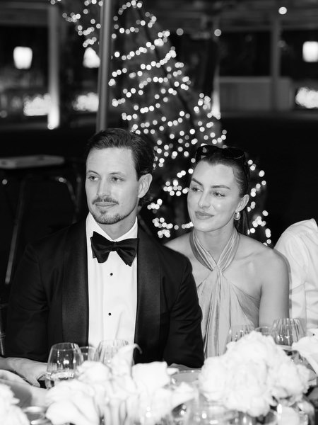 Couple seated during elegant evening reception at Island Resort Athens Riviera wedding.