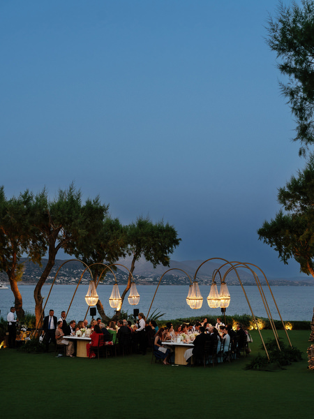 Outdoor wedding reception at night with chandeliers at The Residence Island Resort Athens Riviera.