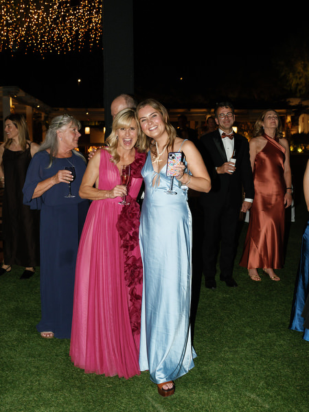 Wedding guests smiling during outdoor evening celebration at The Residence Island Resort Athens Riviera.