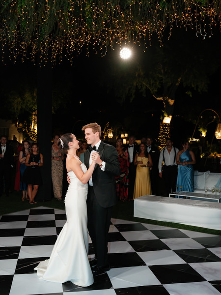 Bride and groom dancing on black and white dance floor at Athens Riviera luxury wedding.