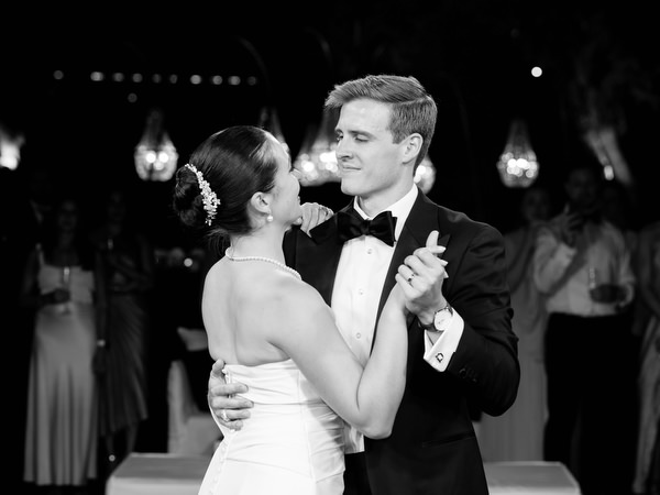 Black and white portrait of bride and groom during first dance at Athens Riviera wedding reception.