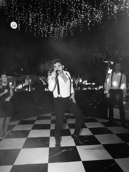 Groomsman dancing during high-energy wedding party at Island Resort Athens Riviera.