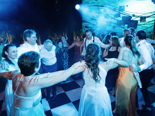 Crowded dance floor with blue lighting at The Residence Island Resort Athens Riviera party.