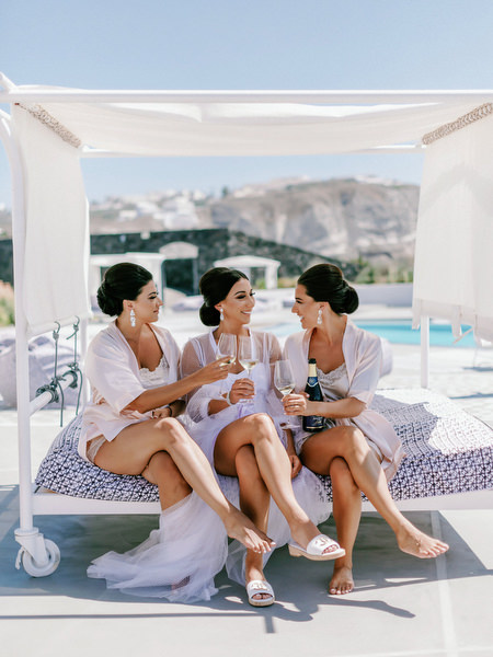 Bridesmaids at Eros Santorini with caldera views.