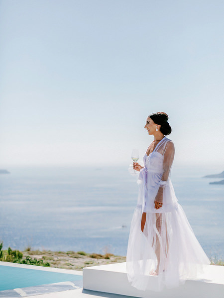 Luxury Santorini wedding portrait overlooking the Aegean.