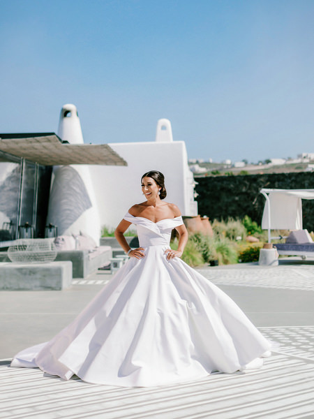 Luxury Santorini wedding gown portrait in white architecture setting.