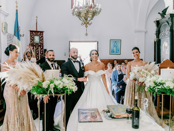 Bride and groom at altar during Santorini wedding ceremony.