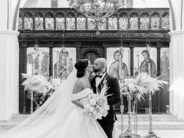 Black and white kiss inside Santorini church.
