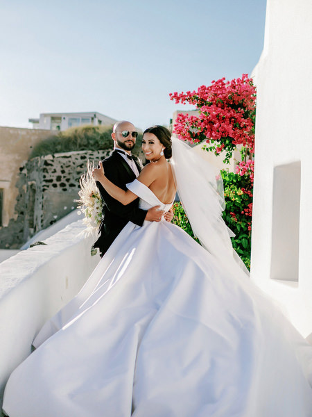 Bride and groom portrait by bougainvillea Santorini.