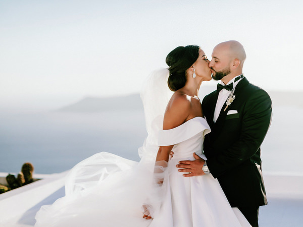 Sunset kiss overlooking Santorini caldera.