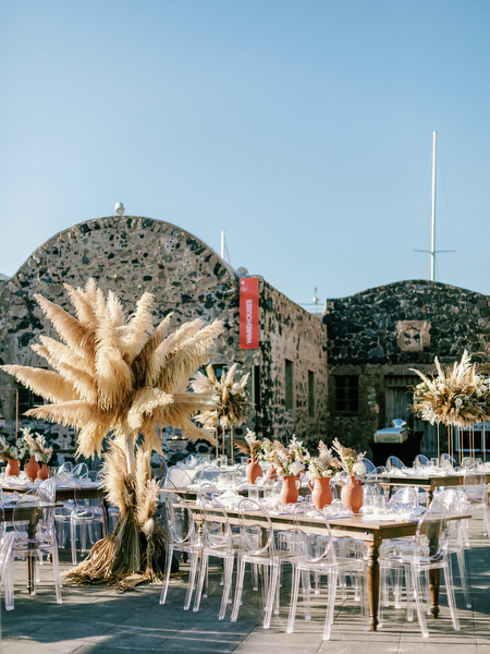 Arts Factory Santorini reception tables with pampas decor.