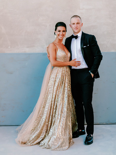 Couple portrait in gold gown at Santorini wedding reception.