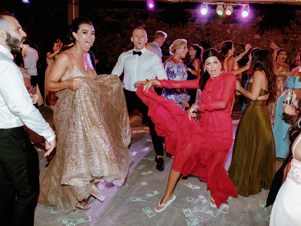 Guests dancing energetically at Jewish wedding Santorini.