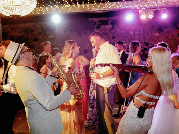 Live musicians performing at Santorini wedding party.
