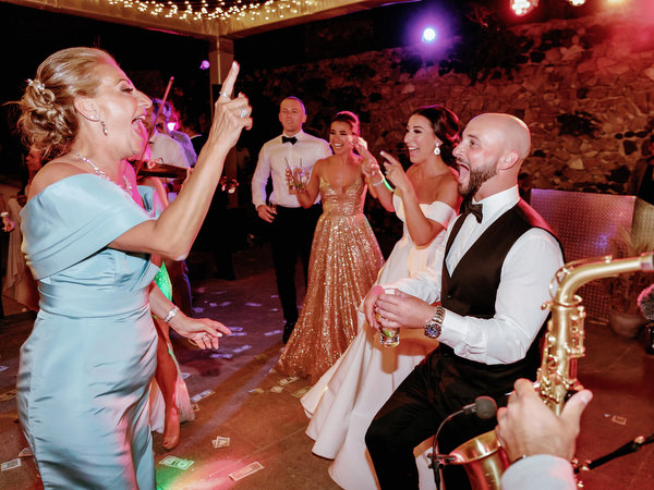Guests dancing wildly at Santorini wedding reception.