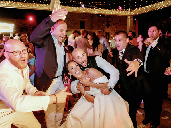 Bride twirling gown on Santorini dance floor.