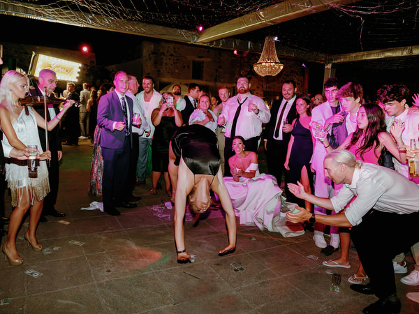 Girl twirling gown on Santorini dance floor.