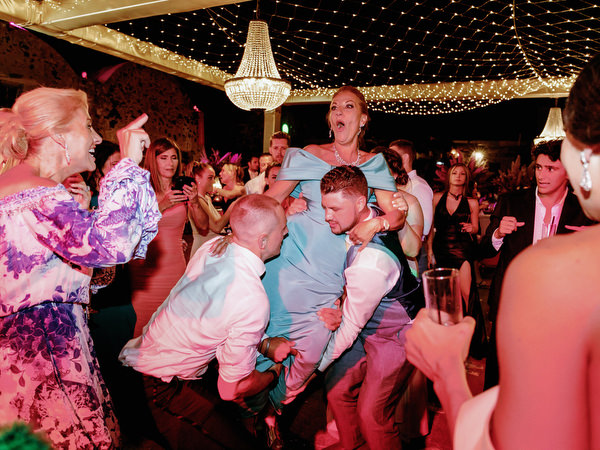 Guests dancing energetically at Jewish wedding Santorini.