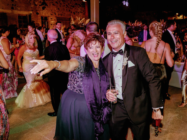Parents celebrating on Santorini wedding dance floor.
