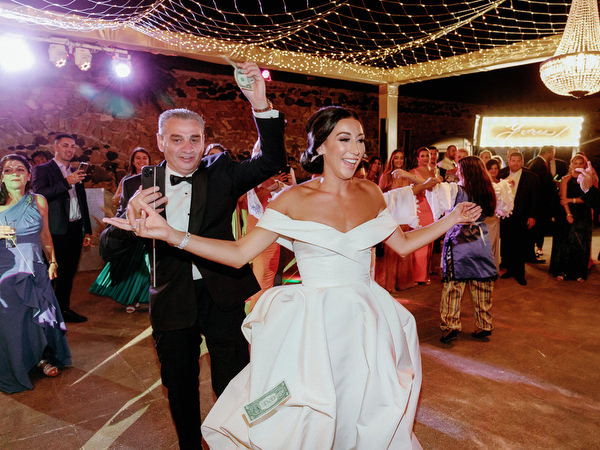 Bride dancing joyfully at Arts Factory Santorini.
