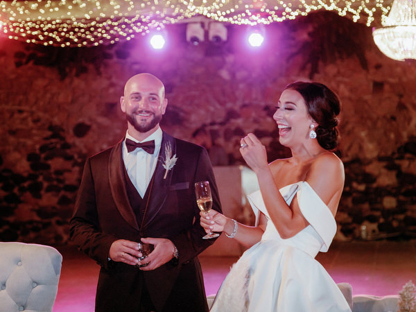 Bride and groom laughing at Santorini wedding reception.