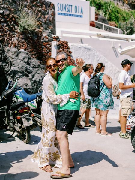 Wedding guests arriving at Santorini harbor for catamaran cruise