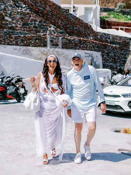 Bride arriving at Santorini marina for wedding catamaran cruise