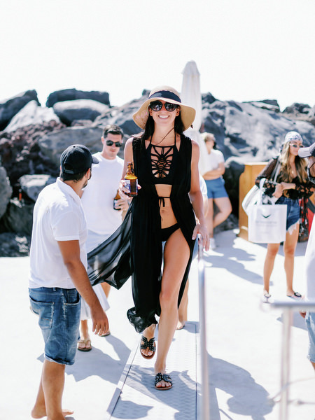 Guests boarding catamaran for Santorini wedding boat party